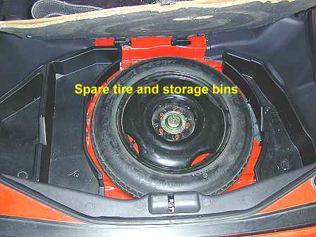 Spare tire and bins in the rear storage compartment