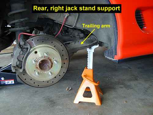 Jack stand under trailing arm; rear
